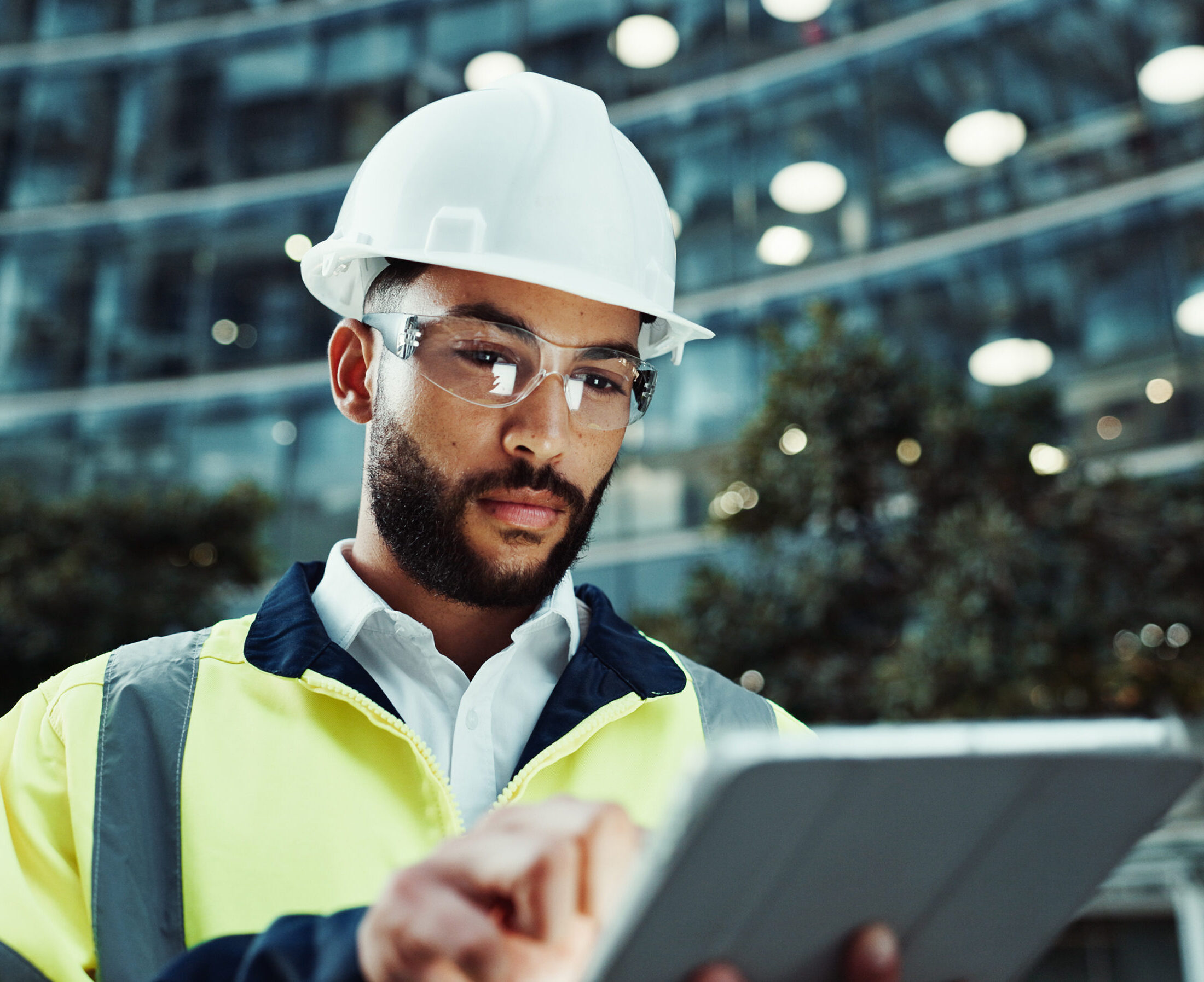 Man in construction looking at tablet